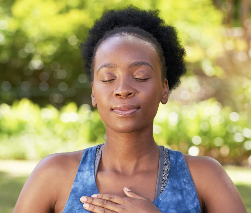 Person practicing grounding and emotional regulation outdoors