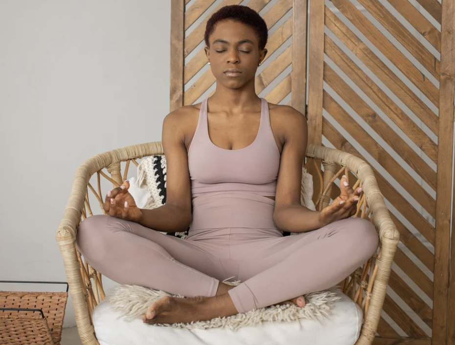 Woman practicing accessible chair yoga while seated